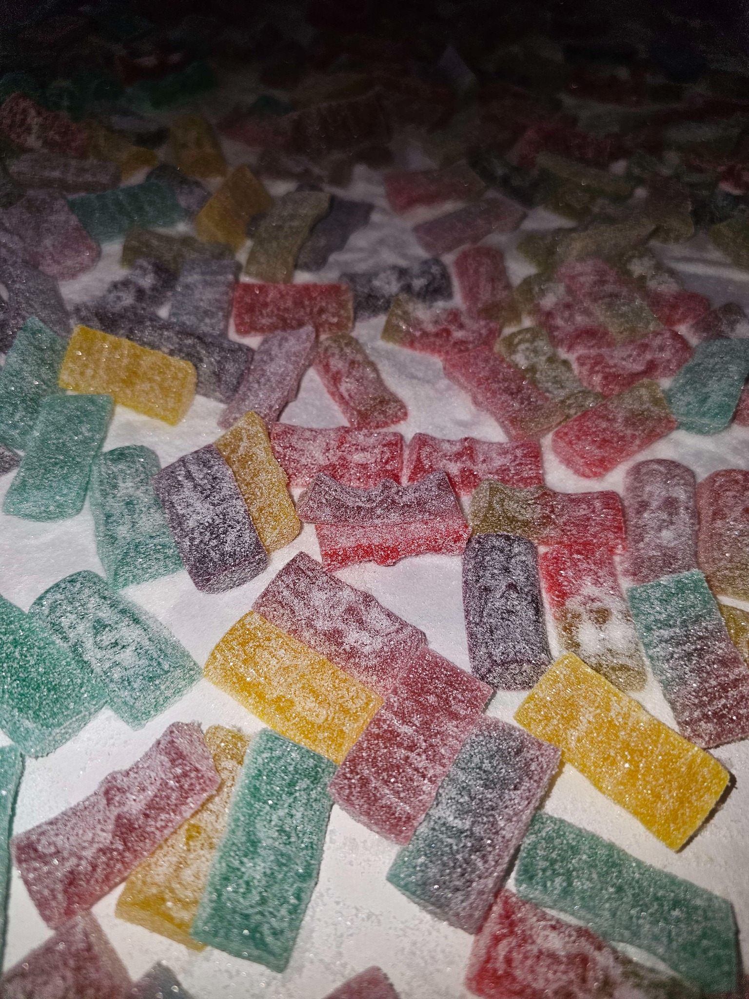 Colourful sugar‑coated rectangles with a light dusting of sugar